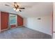 Bedroom with red accent wall, plush gray carpet and light fixture at 622 Tomlinson Ter, Lake Mary, FL 32746