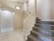 Staircase to the second floor with carpeted steps and a white banister at 622 Tomlinson Ter, Lake Mary, FL 32746