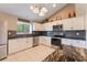 Modern kitchen with white cabinets, stainless steel appliances, and granite countertops at 622 Tomlinson Ter, Lake Mary, FL 32746