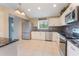 Well-lit kitchen with stainless steel appliances, granite countertops, and white cabinets at 622 Tomlinson Ter, Lake Mary, FL 32746