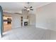 Open-concept living room with fireplace, tile floors, and views into kitchen at 622 Tomlinson Ter, Lake Mary, FL 32746