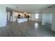Bright kitchen features a large island, white cabinetry, stainless steel appliances, and expansive tile flooring at 7116 Cherry Pasture Rd, Groveland, FL 34736