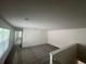 Carpeted upstairs loft area with natural light and ample space for entertaining or relaxing at 7116 Cherry Pasture Rd, Groveland, FL 34736