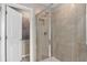Contemporary bathroom with a glass-enclosed shower and neutral tile, offering a clean and modern design at 7274 Summer Ivy Aly, Orlando, FL 32829