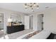 Tastefully decorated bedroom with plush carpeting, designer lighting, and a view into the ensuite bathroom at 7274 Summer Ivy Aly, Orlando, FL 32829