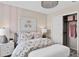 Cozy bedroom boasts stylish decor, soft bedding, and a closet for organized storage at 7274 Summer Ivy Aly, Orlando, FL 32829