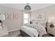 Charming bedroom featuring floral bedding, coordinating artwork, and ample natural light at 7274 Summer Ivy Aly, Orlando, FL 32829