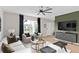 Open living room design with modern furnishings, a view to the entrance and neutral color palettes at 7274 Summer Ivy Aly, Orlando, FL 32829