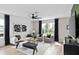 Bright living room featuring modern decor with black accents, and a spacious open-concept design at 7274 Summer Ivy Aly, Orlando, FL 32829
