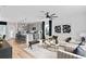 Bright living room featuring modern decor and a spacious open-concept design with a view to the kitchen at 7274 Summer Ivy Aly, Orlando, FL 32829