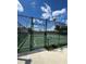 Outdoor basketball court surrounded by a green chain link fence at 7606 Pissarro Dr # 14206, Orlando, FL 32819
