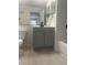 Neutral bathroom featuring gray vanity, black fixtures, subway tile, and bathtub at 7606 Pissarro Dr # 14206, Orlando, FL 32819