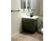 Neutral bathroom featuring gray vanity, black fixtures, square tile floor, and matching mirror at 7606 Pissarro Dr # 14206, Orlando, FL 32819