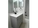 Neutral bathroom featuring gray vanity, black fixtures, and subway tile at 7606 Pissarro Dr # 14206, Orlando, FL 32819