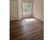 Bedroom featuring vinyl floors, closet, and window with natural light at 7606 Pissarro Dr # 14206, Orlando, FL 32819