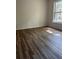 Bedroom with wood-look floors and a view of the property's exterior at 7606 Pissarro Dr # 14206, Orlando, FL 32819
