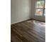 Bedroom with wood-look floors and a window view of a playground at 7606 Pissarro Dr # 14206, Orlando, FL 32819