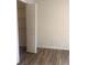 Bedroom featuring wood-look floors and an entrance to the closet at 7606 Pissarro Dr # 14206, Orlando, FL 32819