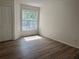 Bedroom with vinyl floors and window with natural light at 7606 Pissarro Dr # 14206, Orlando, FL 32819