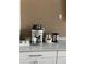Coffee station includes a modern espresso machine, cabinets, and supplies for guests at 7606 Pissarro Dr # 14206, Orlando, FL 32819