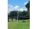 Community area featuring a pier, picnic table, lush green space and blue sky at 7606 Pissarro Dr # 14206, Orlando, FL 32819
