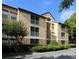 Spacious condominium building with a well-maintained facade and lush landscaping at 7606 Pissarro Dr # 14206, Orlando, FL 32819
