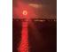 Night view of a celebratory fireworks display reflected across the water at 7606 Pissarro Dr # 14206, Orlando, FL 32819