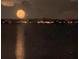 Distant yellow fireworks display over water with building lights across the horizon at 7606 Pissarro Dr # 14206, Orlando, FL 32819