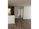 Open concept living area featuring laminate flooring and neutral paint at 7606 Pissarro Dr # 14206, Orlando, FL 32819