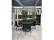 A shaded outdoor table and chairs sit on a quaint patio, offering a serene seating area at 7606 Pissarro Dr # 14206, Orlando, FL 32819