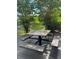 A picnic table with a marble top and benches provides an outdoor dining area with a natural view at 7606 Pissarro Dr # 14206, Orlando, FL 32819