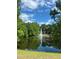 Scenic pond with a fountain surrounded by lush greenery offering a peaceful community amenity at 7606 Pissarro Dr # 14206, Orlando, FL 32819