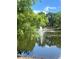 Scenic pond with a fountain surrounded by lush greenery offering a peaceful community amenity at 7606 Pissarro Dr # 14206, Orlando, FL 32819