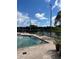 A lovely pool with lounge chairs offers a peaceful retreat with a tranquil lake backdrop at 7606 Pissarro Dr # 14206, Orlando, FL 32819