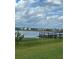 Expansive water view featuring a wooden pier in a community with manicured lawns and clear skies at 7606 Pissarro Dr # 14206, Orlando, FL 32819