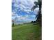 Beautiful water view featuring palm trees, community pier, manicured lawns and clear skies at 7606 Pissarro Dr # 14206, Orlando, FL 32819