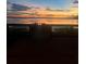 Picturesque sunset view over the water, captured from a wooden dock with railing at 7606 Pissarro Dr # 14206, Orlando, FL 32819