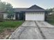Charming single-story home featuring an attached two-car garage at 7625 Jarvis Ct, Orlando, FL 32818