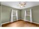 Cozy bedroom with hardwood floors, two windows providing ample natural light, and neutral wall color at 826 S Montgomery Ave, Deland, FL 32720
