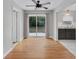 Bright dining room with wood floors, a sliding glass door, and open access to the kitchen at 826 S Montgomery Ave, Deland, FL 32720