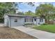 Charming single-story home with a well-maintained lawn, long driveway, and freshly painted exterior at 826 S Montgomery Ave, Deland, FL 32720