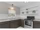 Galley-style kitchen features granite countertops, stainless steel appliances, and ample storage at 826 S Montgomery Ave, Deland, FL 32720