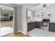 Updated kitchen with gray cabinets, stainless steel appliances, and a view of the spacious backyard at 826 S Montgomery Ave, Deland, FL 32720