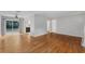 Open-concept living room featuring hardwood floors and access to the kitchen at 826 S Montgomery Ave, Deland, FL 32720