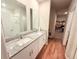 Bathroom featuring a double vanity with white cabinets, granite countertops and tile floors at 877 Rivers Crossings St, Clermont, FL 34714