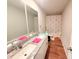 Well-lit bathroom features a double-sink vanity with granite counters, a toilet, and a shower/tub combo at 877 Rivers Crossings St, Clermont, FL 34714