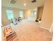 Spacious bonus room with toys, neutral paint, two windows, and carpeted floors at 877 Rivers Crossings St, Clermont, FL 34714