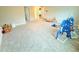 Large bonus room with neutral walls, carpeted floors, and toys at 877 Rivers Crossings St, Clermont, FL 34714