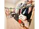 Walk in closet with custom closet organizers and carpeted floors at 877 Rivers Crossings St, Clermont, FL 34714
