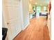 Open-concept hallway with wood-look floors leading to the kitchen and living area at 877 Rivers Crossings St, Clermont, FL 34714